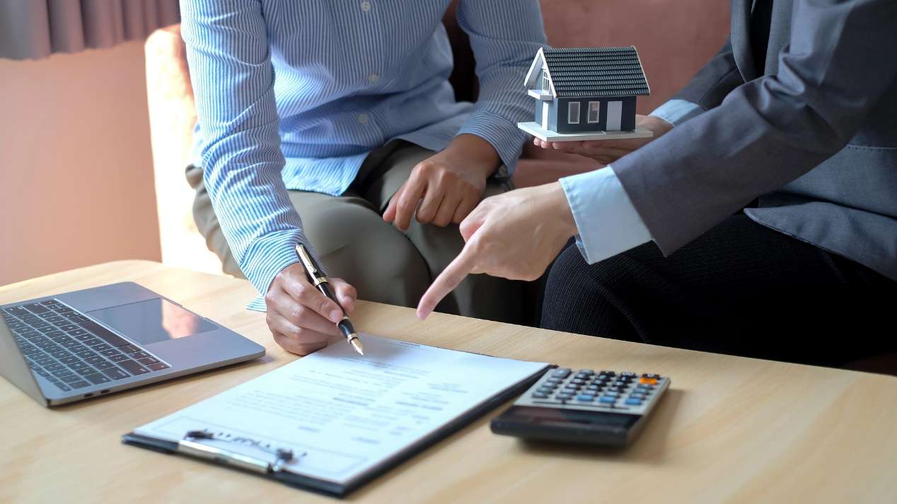 Toronto landlord reviewing financial documents related to capital gains tax before selling a rental property